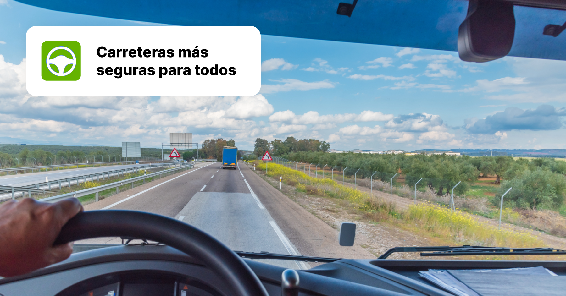 Vista desde la perspectiva de un conductor de camión en una autopista con el mensaje "Carreteras más seguras para todos", destacando la importancia de una conducción segura.