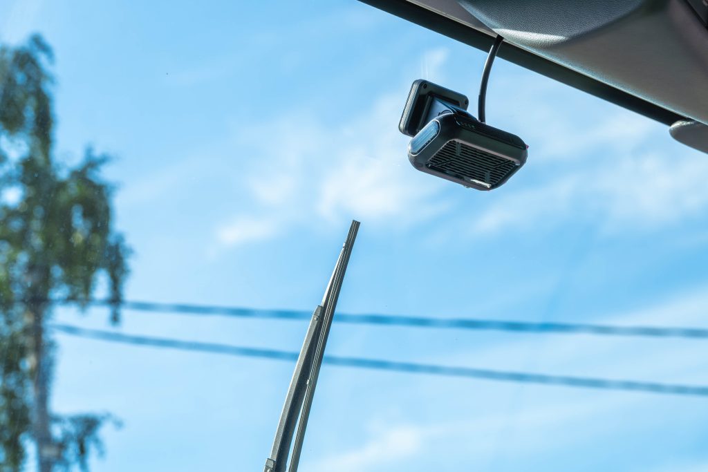 A fleet camera mounted on the windshield of a street sweeper.