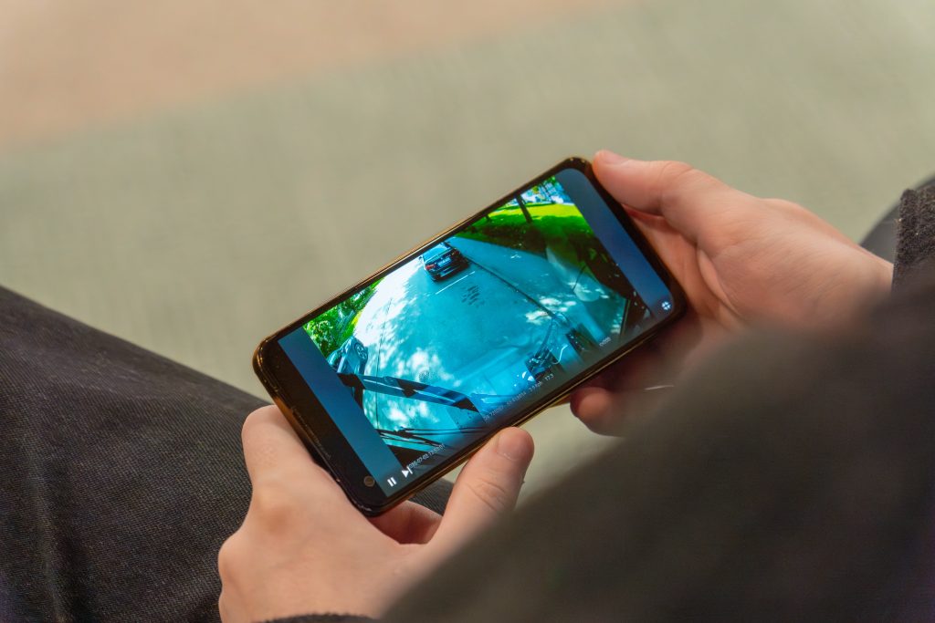 A street sweeper video recording playing on a smartphone screen.