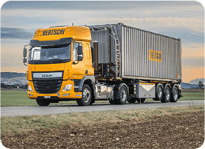 An orange long haul truck of transport company Bertschi.