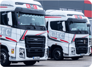 Two white long haul trucks of transport company RMC - Transports.