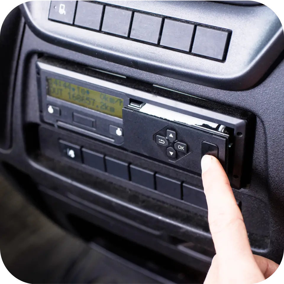 Close-up view of a second-generation smart digital tachograph installed in a vehicle for remote tachograph download.