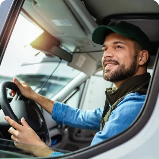 A truck driver sitting in a vehicle.